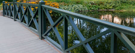 The bridge across a small pond surrounded by flowersの写真素材