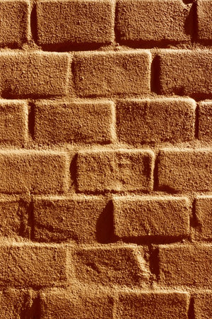 Brick wall painted brown in sunlight