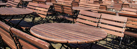 ound empty wooden brown tables with benchesの写真素材