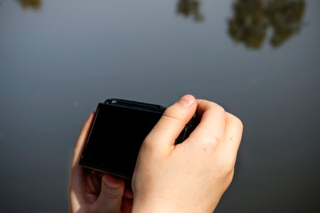 Hands of a child holding a camera