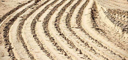 Pattern of tracks from a car on the sandの写真素材