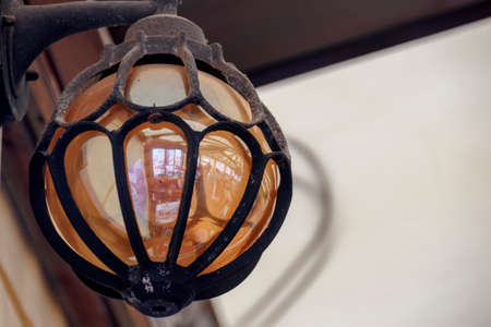 Sand-covered street lamp with a reflection of people in a cafeの写真素材