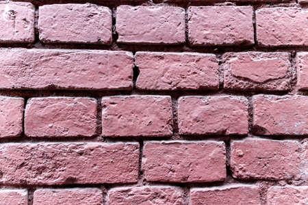 Wall of baked bricks colored in deep pink texured backgroundの写真素材