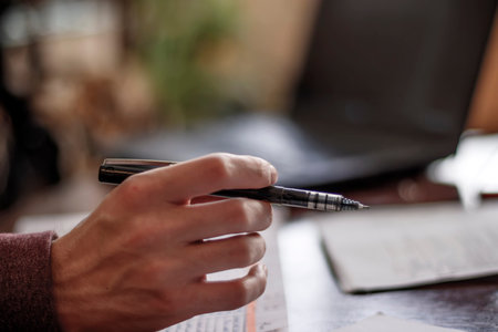 Hand of a man with a penの写真素材