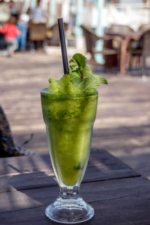 A glass with an ice drink made of nana and lemonの写真素材