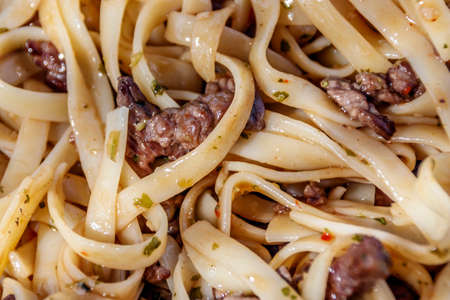 Spaghetti with slices of meat top view close-upの写真素材