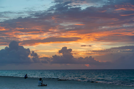 People sitting on the seashore and photographing