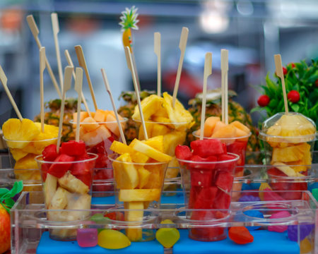 Plastic cups with fresh fruit dessert
