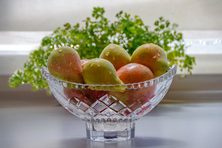 Ripe apples and pears in a crystal vase