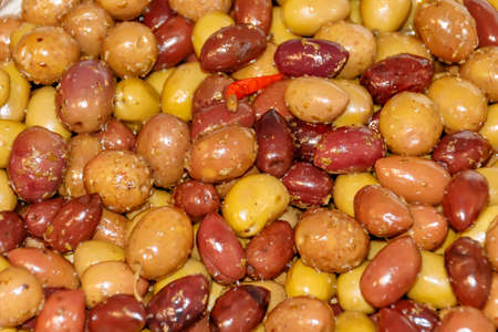 Salty fruits of olive tree with red peppeの写真素材