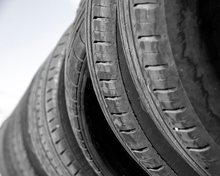 utomobile tires stacked in a row close up