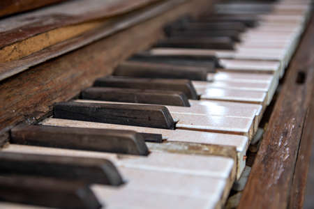 Dirty cracked keys of the old piano close-up. Retroの写真素材