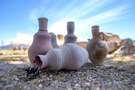 Ancient amphoras against the backdrop of the ruins of the historic city of Zipory, National Park,...