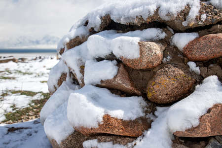 Pile of granite cobblestones covered in snow. Traveling in Kyrgyzstan.の写真素材