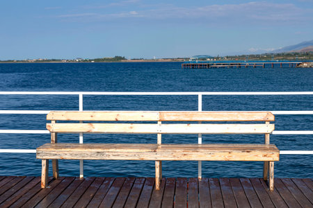Bench on a wooden pier on Issyk-Kul Lake. Kyrgyzstan