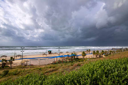 View of the city beach, sea and sky in clouds during a storm. Israelの写真素材