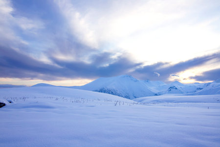 Snow-capped mountains on Cross Pass Georgian Military Highway during sunset. Georgia
