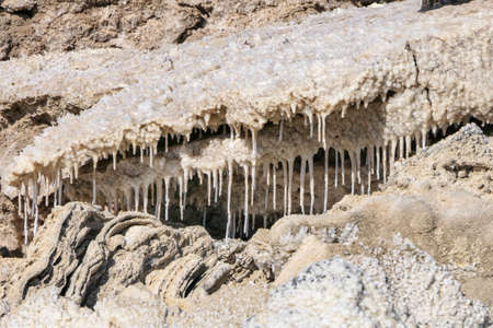 Ecological catastrophe of the disappearing Dead Sea. Erosion and salt formations on the surface of the earth. Israelの写真素材