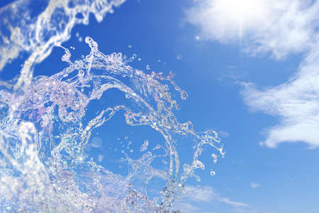 Summer blue sky, sun and splash of the seaの写真素材
