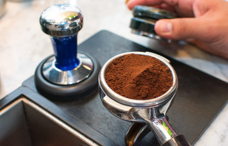 delicious coffee preparation with portafilter and tamper, professional concept