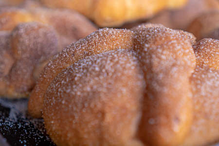 Exquisite traditional Mexican bread made with orange with sugar on top, Mexican style with a black background.の写真素材