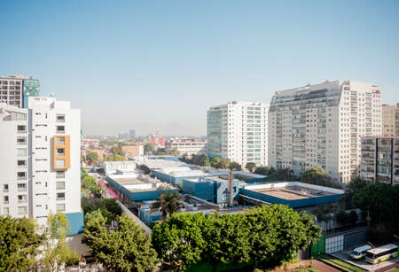 Incredible panorama of the city with modern buildings, trees, houses and streets with the blue sky in the background in Mexico City.のeditorial素材