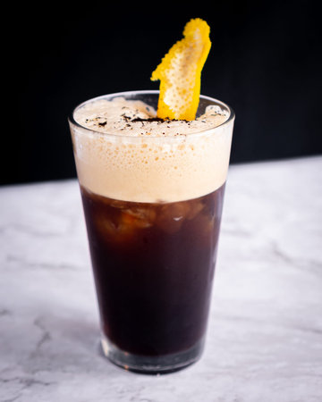 Delicious carajillo prepared with a shot of espresso coffee and a shot of liqueur served in a clear...