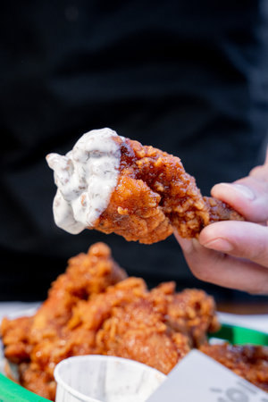 Hand dipping a wing on ranch dressingの写真素材