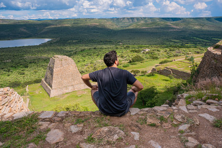 white tourist visiting the pyramids of Mexico in la quemada zacatecas with a spectacular view, tourism and travel concept.の写真素材