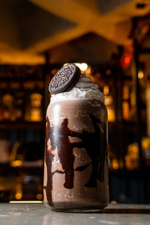 Delicious and fresh coffee frappe with dark chocolate and chocolate cookie, served in a transparent...