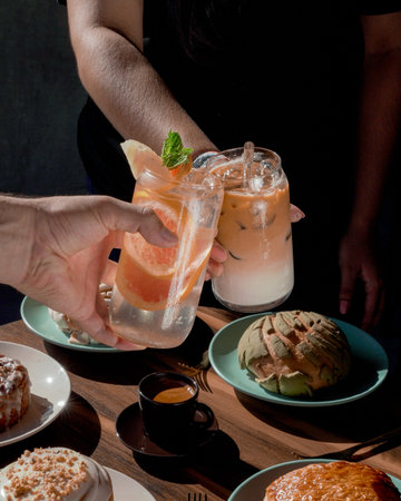 people drinking lattes on the rocks and lemonade, with delicious bread, inside a coffee shop.