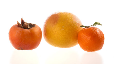 Grapefruit, khaki and mandarin on white background