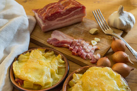 Two small tartiflettes, with pork belly, onions and garlicの写真素材