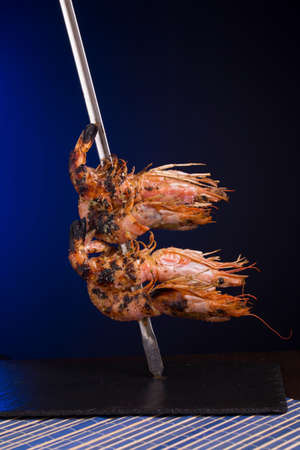 Grilled prawns served on a white backgroundの写真素材