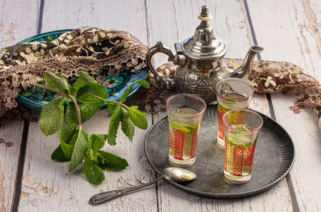 Glasses of mint tea on a tray on tableの写真素材