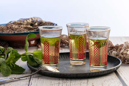 Glasses of mint tea on a tray on tableの写真素材