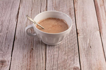Bowl of hot chocolate in the morning on a wooden tableの写真素材