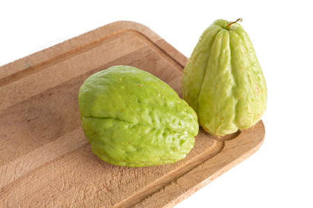 Chayote on a cutting board on a white backgroundの写真素材
