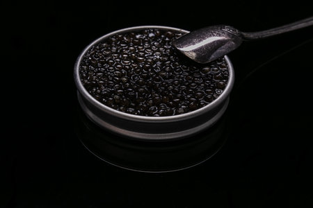 Caviar in a metal box on black backgroundの写真素材