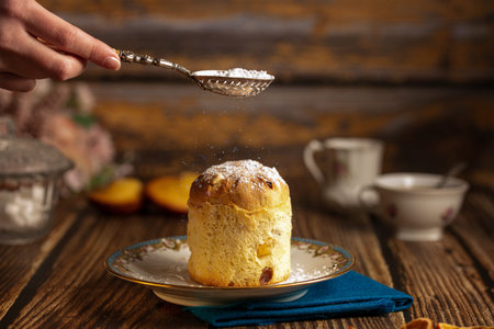Small cake in a plate on a wooden table