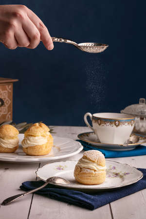 Vanilla cream puffs, for a snack, on a wooden tableの写真素材