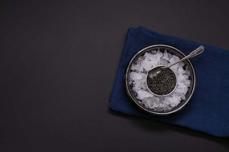 Caviar in a metal box on black backgroundの写真素材