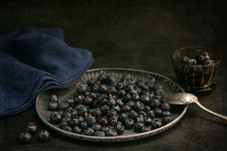 Raw blueberries in a tray on a dark backgroundの写真素材