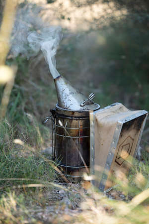 Smoke machine for beekeeping farm posed in the grassの写真素材