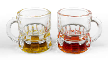 Two Little Pitchers Containing Yellow and Red Drinksの写真素材