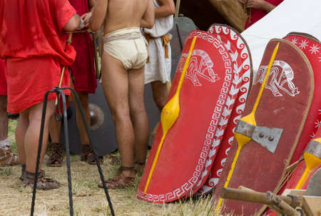 A set of legionary shields and a group of soldiers in an ancient roman encampmentの写真素材