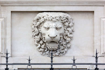 Roaring lion head high-relief on the facade of a palaceの写真素材
