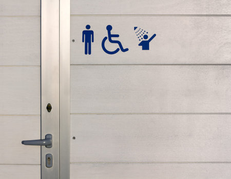 Blue Signs over the exterior wall of a beach gents public bathroomの写真素材