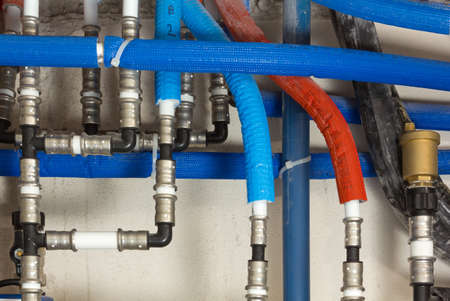Gas and water pipes with colored coatings in a boiler roomの写真素材