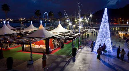 Kiosks and a Christmas Tree by night at the waterfront of Malaga, Spainの写真素材